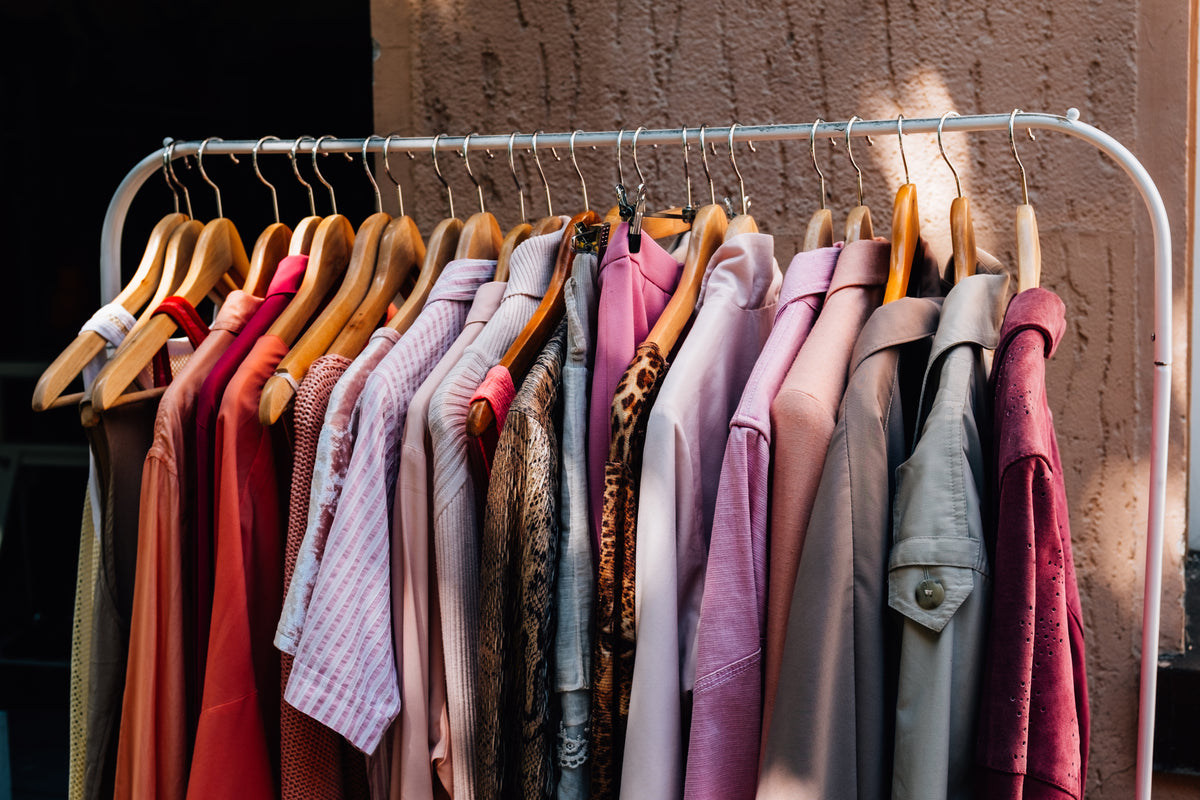 metal-clothing-rack-with-warm-colored-clothing.jpg